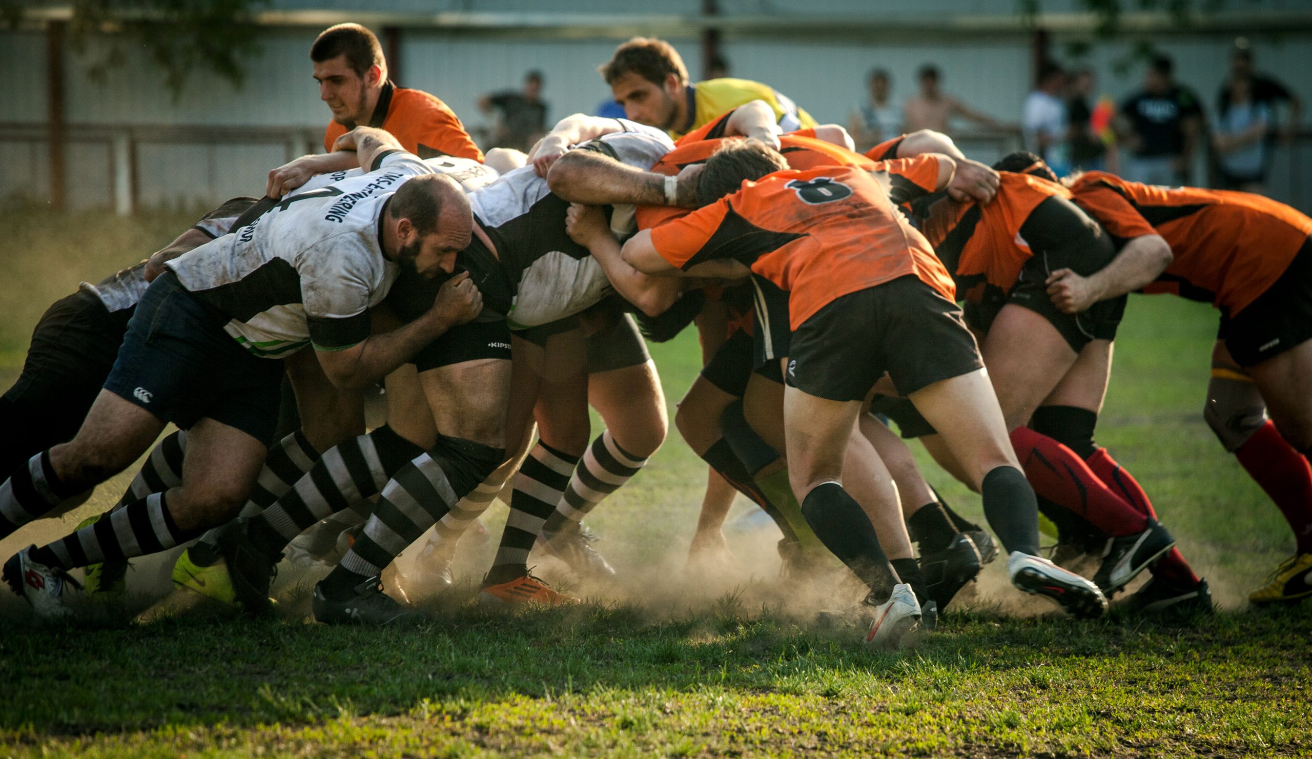 A rugby scrum where one team has used "retrospectives" to continuously improve and is now winning