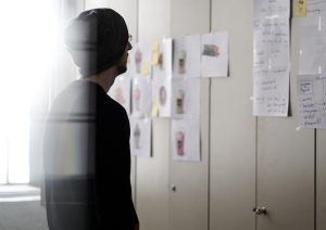 Person looking at a design driven project plan up on the wall