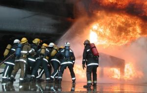 Firefighters apply maximum effort in a situation as they fight a fire together as a team