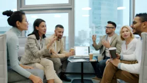 A group of people communicating around a table