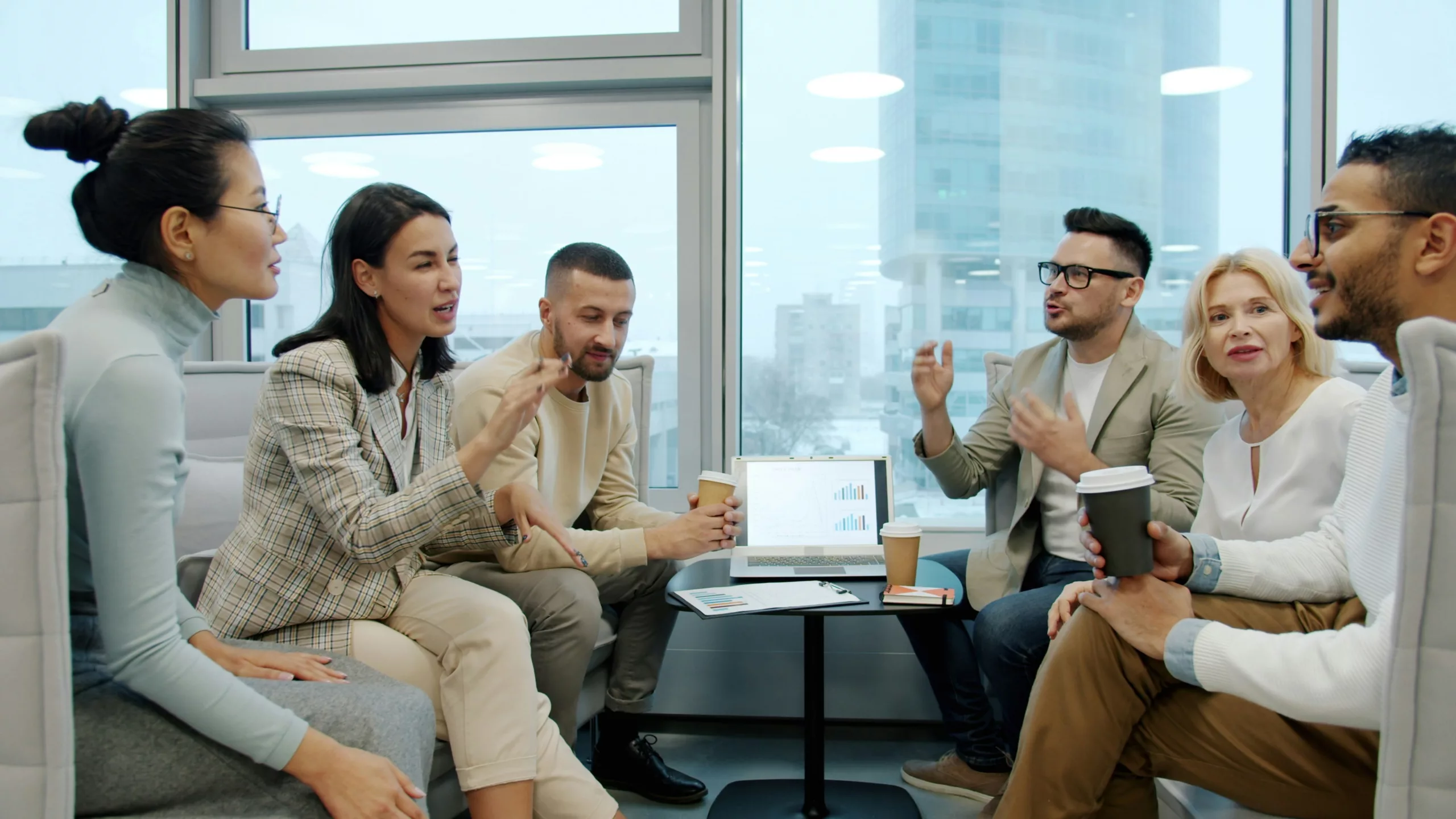 A group of people communicating around a table